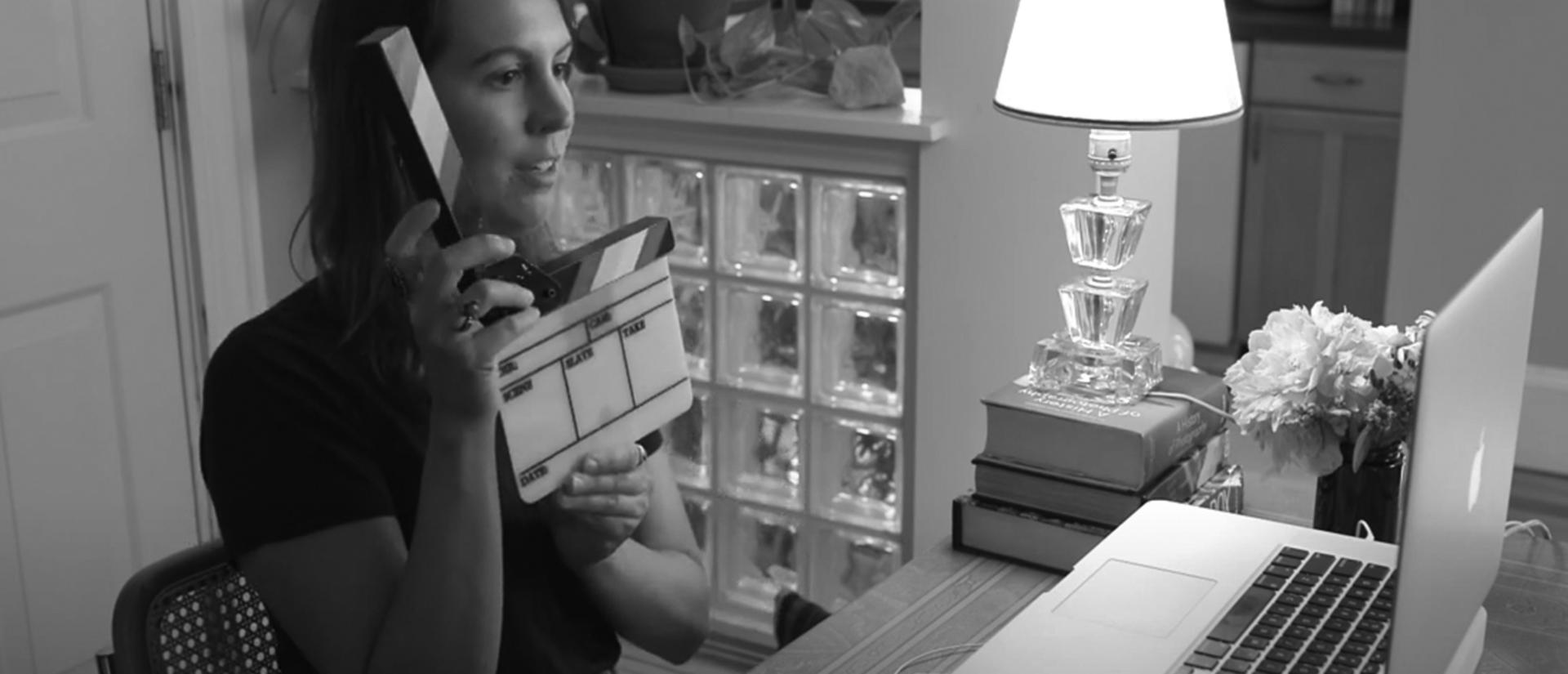 Photo of woman recording video at her home computer