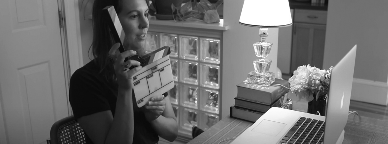 Photo of woman recording video at her home computer